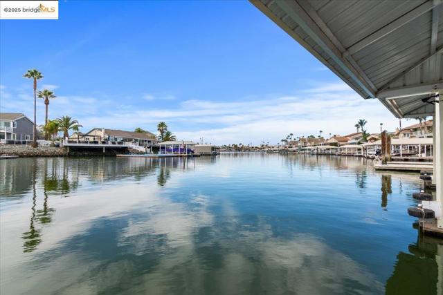 Dock featuring a residential view and a water view