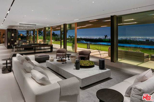 9344 Nightingale Drive Los Angeles, California Capturing extraordinary views from a private promontory in the Bird Streets, this spectacular new contemporary estate was envisioned by architect Zoltan Pali and home builder Dugally Oberfeld. Positioned to maximize far-reaching canyon, city and ocean views, the home fuses indoor-outdoor living with a stunning 60 long retractable skylight and automated glass pocket doors. Showcasing exquisite design, interiors include 2 Poliform kitchens, magnificent great room, office, media room, wine storage and wellness center with sauna, steam, gym and saltwater floating pod. 6 bedrooms include an exquisite primary suite with terrace, custom Italian bed, Poliform dressing room and gorgeous bath with textured marble walls. Amenities include a 106 pool with Baja shelf, heated spa, floating lily pad and fire pit lounge. An architectural masterpiece on a quiet cul de sac, the home offers privacy and serenity, moments from Beverly Hills, West Hollywood and Coldwater Canyon.