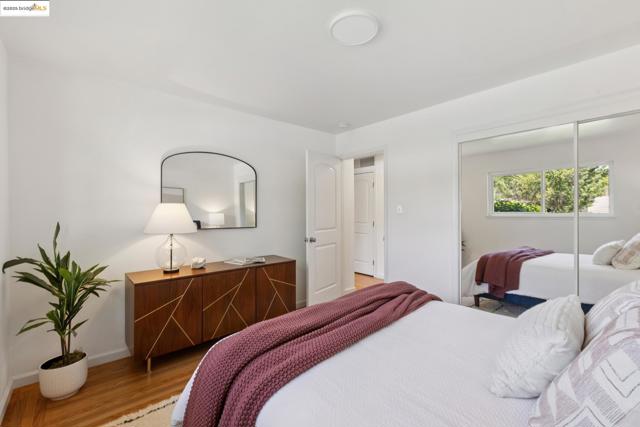 Bedroom with wood finished floors and a closet