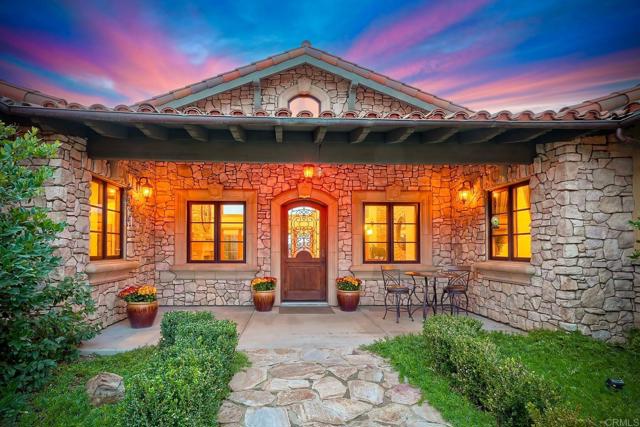 A flagstone walk-way leads to a beautiful courtyard entry.