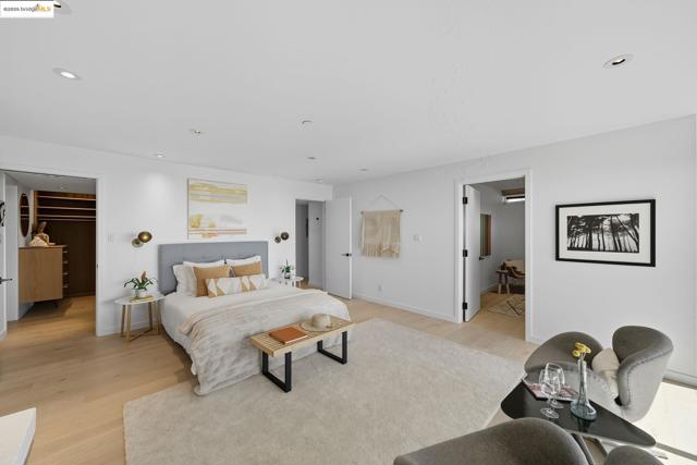 Bedroom featuring recessed lighting, light wood-style floors, and a spacious closet