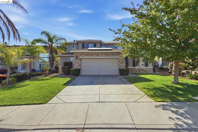 Two-story exterior with stone facade accents and a two-car garage