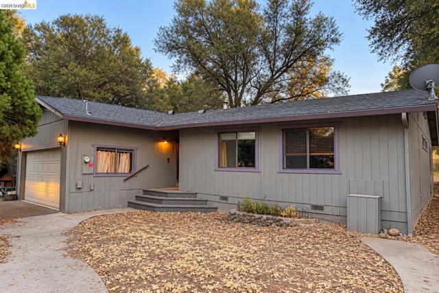 Single-story exterior with an attached garage, multi-level entry stairs, and a paved walkway