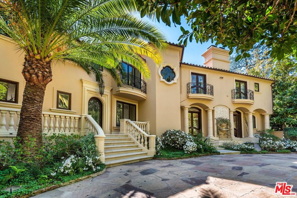 Behind a prestigious double-gated entry, just moments from the heart of Beverly Hills, lies this sophisticated Tuscan Villa offering timeless elegance and luxurious living. Meticulously crafted with exquisite finishes, the home features limestone and hardwood floors, soaring coffered and beamed ceilings, and arched doorways that evoke classic European charm. A grand step-down living room, framed by French doors, opens to the lush and private backyard, creating a seamless indoor-outdoor flow. The main level also includes a richly wood-paneled office or den, a formal dining room ideal for entertaining, a private gym, and a spacious chef's kitchen equipped with a large center island, professional-grade appliances, and a sunlit breakfast area. A sweeping staircase ascends to the stately primary suite, introduced by double doors and complete with a serene sitting area, white onyx fireplace, pocket French doors, a private terrace, an expansive walk-in closet, and a luxurious spa-like bath featuring dual vanities, a sauna, soaking tub, and separate shower. Two additional en-suite bedrooms are located upstairs, with a maid's quarters conveniently situated on the lower level. The beautifully landscaped backyard is a tranquil oasis, perfect for entertaining, with generous patio space, built-in BBQ, and a sparkling pool. This exceptional offering also includes an additional parcel (APNs: 4352-006-039 & 4352-006-040), providing even more value and potential.