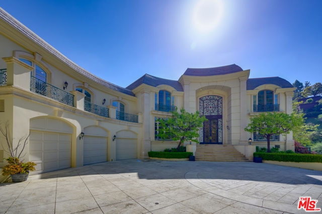 This grand Contemporary Mediterranean estate is located up a private drive at the end of a secluded cul-de-sac. Enter through gates to an impressive motor court with parking for up to 20 cars and a 6 car garage. The home features large rooms and high ceilings, tall impressive iron and glass entry doors, a two-story entry, marble floors, an elevator, double powder rooms, and a second-floor family area. The 11,251 sq. ft. of interior features 7 bedrooms, 9 baths, a gourmet kitchen with a double island with granite counters, breakfast room with French doors. Spacious family room featuring hardwood floors, wet bar, fireplace, and French doors that lead to a grass lawn and pool with spa and cabana, secondary yard provides room for a sports court and/or children's play area. The formal library includes a loft. Spacious master bedroom with fireplace, separate his and her baths, large walk-in closets, large private balcony with views of the pool.
