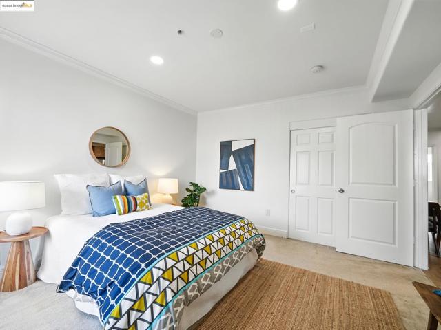 Carpeted bedroom with crown molding and recessed lighting
