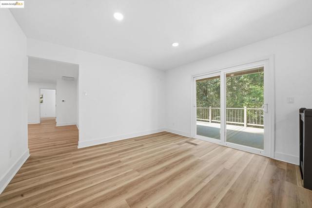 Unfurnished living room with light wood-type flooring and recessed lighting