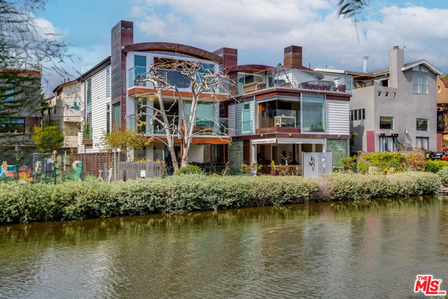 427 Carroll Canal Venice, California Introducing the Carroll Canal Compound located in one the most iconic residential communities. Two beautiful Architectural gems sit side by side with 60 feet of frontage on the historic Venice Canals. First time on the market these custom homes have adjoining lots with separate APNs. The properties offer many options for live/work, family/guests or just a magical artist compound. Both houses are 3 story structures with an abundance of natural light, elevators to all floors, 2 car garages and share the large back yard with built-in BBQ and Koi pond. The main house at 427 has floor-to-ceiling Fleetwood walls of glass on the upper and lower floors. The entry level is a gorgeous area with ultimate indoor/outdoor spaces. 2nd floor has two bedrooms, two bathrooms and a living room. The 3rd floor is a dedicated private master suite opening out to a rooftop deck with a wet bar, spa and fantastic views of the canals. The 2nd house, 425 is similar on its exterior, but the interiors are uniquely its own with 3 bedrooms and 2 baths. The main level includes a great living room with private deck, modern kitchen and a breakfast area. The top floor has 2 en-suite bedrooms, one of which has wood barreled ceilings with an extraordinary view. This is a setting that should not be missed. Close to beach, restaurants, shops and all things Venice.