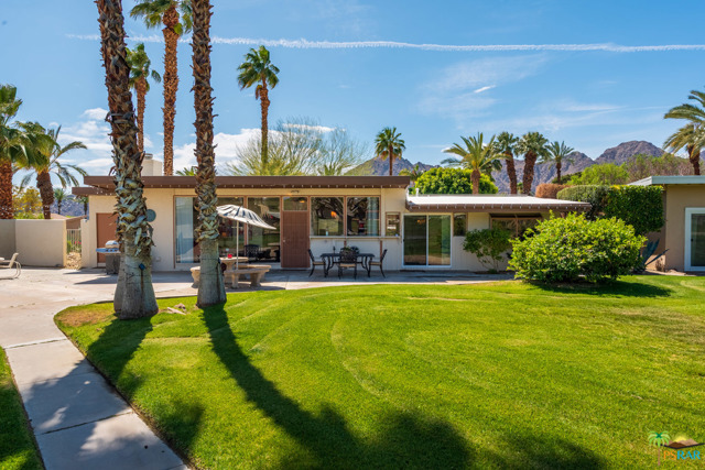 77390 Cheyenne Drive Indian Wells, California Welcome to this rarely offered on the market Mid-century modern gem located in the prestigious city of Indian Wells. 3 Bedroom, 2 Bath offering 1,371 Sq Ft. of living space on a large corner lot. Enjoy the light and bright open floor plan offering a fresh natural light feeling throughout. This property boasts large sized ceramic tile flooring throughout common areas, spacious bedrooms, generous sized closets, and updated bathrooms. The updated and open kitchen work space with snack bar, and adjacent spacious living room with walls of glass with views of greenbelt, and a stacked stone fireplace for your entertaining needs. Embrace the great outdoors and the views from large patio off living room. Located in the quiet community of Indian Wells Village offering large community park like setting with lush greenbelts, mountain views, community pool and a full-size sand volleyball court. Walking distance to the famed Indian Wells Tennis Gardens and more. Offered furnished per inventory. Low HOA dues. Do not miss this rare opportunity to own a home in one of the most sought after cities in the Coachella Valley.