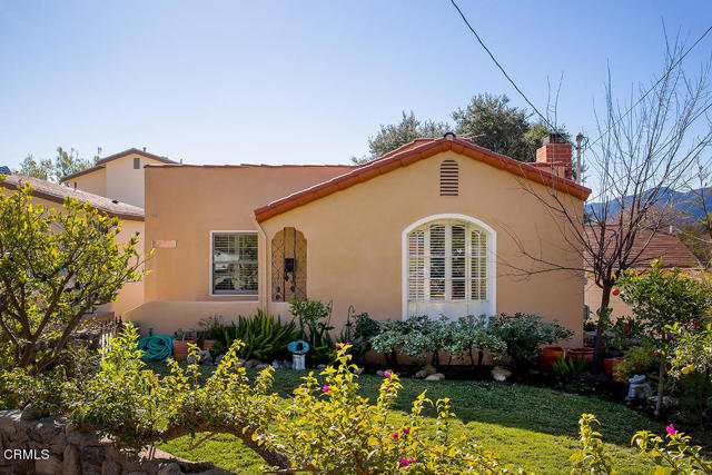 2826 Stevens Street La Crescenta, California Exquisite and meticulously updated 1926 Spanish style home with an abundance of character and curb appeal. Located above Foothill Blvd, this unique dwelling is in close proximity to Monte Vista Elementary School, Rosemont Middle School, Crescenta Valley High School and Two Strike Park. The charming Spanish architecture can be felt throughout the home from the large colonial arched window that brightens up the living room, to the hardwood flooring, a cozy fireplace setting, plantation shutters and trayed plastered ceilings. The eat in kitchen has been tastefully remodeled with custom white cabinetry, white quartz countertops, Spanish tile flooring, trayed ceiling and stainless-steel appliances. The long paving stone driveway leads to a two car plus detached garage and entertainer's backyard. The beautiful lush green grassy backyard with fruit trees has lovely views of the majestic Verdugo Mountains and is perfect for outdoor dining. Some other nice features of this home include: Newer dual pane windows, updated electrical, copper plumbing, a remodeled bathroom, and heavy duty glass screen doors that let in an abundance of light. This home is move in ready!
