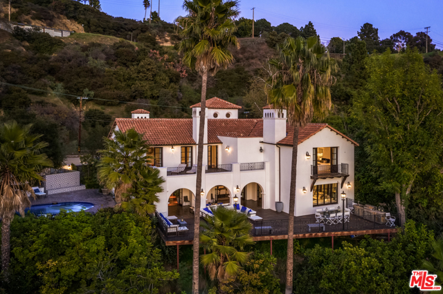2819 Coldwater Canyon Drive Beverly Hills, California Nestled behind lush landscaping in a star studded area of Coldwater Canyon, this completely updated Spanish villa is perfect for any buyer. Enter through the dramatic 30' foyer into the formal living and dining rooms with stunning canyon views. The home seamlessly transitions from indoor to outdoor from all lower level rooms. With over 3,000 SqFt of flat outdoor space it is ideal for entertainment and the outdoor dining experience. The chef's kitchen, complete with an oversized Carrera marble island and Viking appliances, flows right into the spacious family room with an abundance of natural light. Custom beamed ceilings and beautiful walnut flooring throughout. The master suite epitomizes luxury living with a romantic fireplace, dual closets, an expansive bathroom and a private balcony. All four bedrooms are upstairs and three boast jaw-dropping views of the canyon and the grounds. Surrounded by an exquisite 25K SqFt lot, the sun-soaked pool and massive deck are idyllic for relaxation