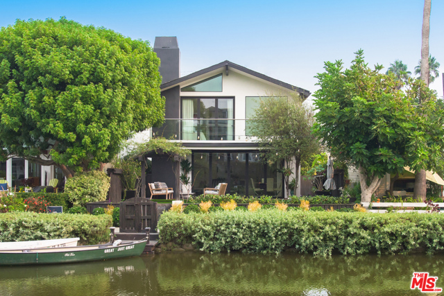 214 Howland Canal Venice, California On an island in the Venice Canals, this warm, inviting home is extensively remodeled with exquisite taste, custom quality, and timeless contemporary flourishes. Designed for casual entertaining and stylish everyday living, the open-concept space features a chefs kitchen with a massive center island, Miele and SubZero appliances, and Quartzite counters that flows to the bright & airy living area with bleached white oak floors. A retractable glass wall leads to the comfortable outdoor terrace with heaters and speakers, a beautifully landscaped yard, and your own boat dock. The master retreat features vaulted ceilings, a glass wall opening to a canal-front balcony, a walk-in closet, and an incredible bath with a spa-like shower. Two bedrooms, a bath with jetted tub, a sky-lit office nook, and a huge back deck round out the second floor. Outfitted with tech comforts, HVAC, Sonos smart home system, security cameras, and more. Minutes from the beach and Abbot Kinney shops and restaurants.