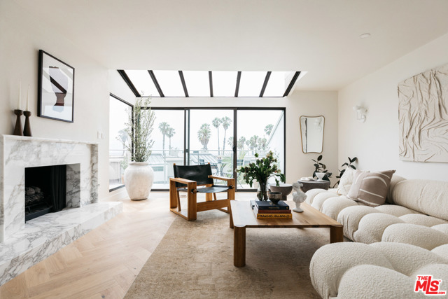 39 Sea Colony Drive Santa Monica, California Open your windows morning and night to the sound and scent of the Pacific Ocean. This 2 bedroom + office, 2.5 bathroom home is situated steps from the beach and the best Santa Monica has to offer like the farmers market, 3rd Street Promenade, the pier and Main Street's restaurants and shops. Tucked away in the highly sought-after Sea Colony community, you will love the private end-unit townhome that boasts gorgeous sand and ocean views - perfect for a primary residence or a dreamy vacation retreat. From the moment you step inside, you will be in awe of this beautiful home which has been recently updated with not a single inch left untouched. There is custom herringbone wood flooring, two marble fireplaces, designer fixtures, custom cabinetry/closets, and top of the line Miele kitchen appliances. Perfect for entertaining, your friends and family will love the private patio on the lower level in addition to the oversized balcony and bonus space overlooking the ocean. Equal attention to detail was given to the private quarters as well including a luxurious primary suite you will never want to leave. Offering a custom walk-in closet and incredible spa-like ensuite with a floating dual vanity, soaking tub and skylight, it doesn't get much better than this. Private two car garage with direct access.