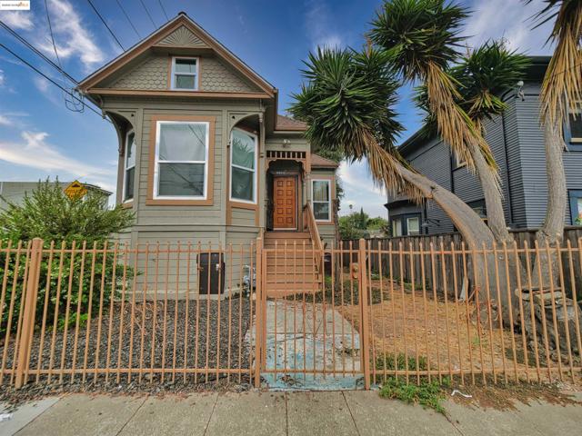 Victorian-style house featuring a fenced front yard and a gate