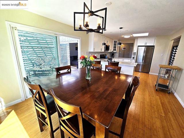 Dining area featuring light wood finished floors and a chandelier
