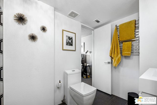 Modern Utilities with Towel Warmer in Primary Bath