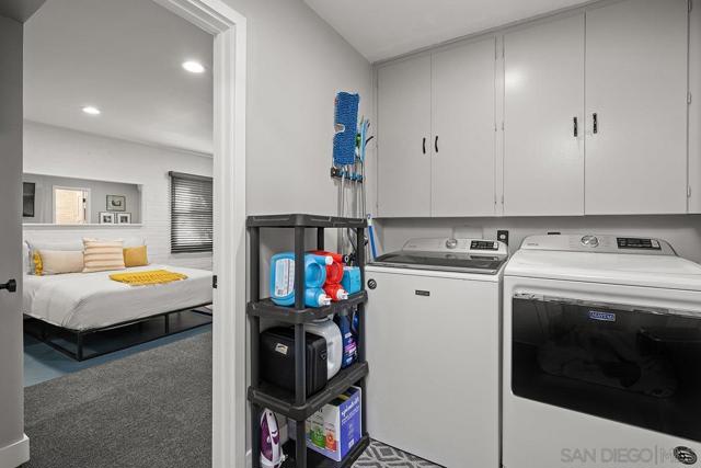 Separate laundry area with built-in cabinets.