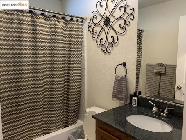 Full bath with vanity and shower / bath combo