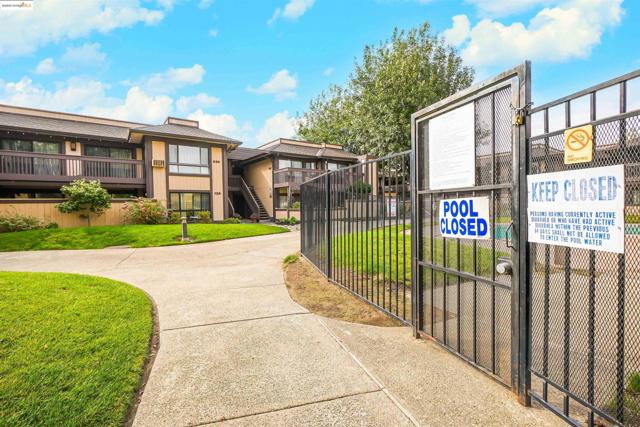 Surrounding community with a gate, stairway, and a residential view
