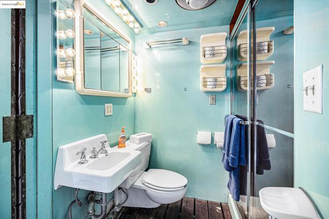 Bathroom with toilet and wood finished floors