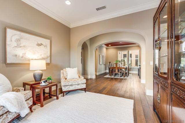 Elegant Seating Area off the dining room, featuring French doors that open to the backyard for seamless indoor-outdoor living.