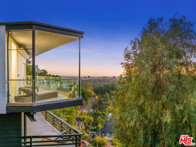 1449 Summitridge Drive Beverly Hills, California While most homes are derived from design, 1449 Summitridge is bonafide artwork. Behind a unique Art Deco facade and on a double lot is just under 2000 sqft of curated space. The home consists of 2 spacious bedrooms and 2 bathrooms with a non-permitted third full bath on the lower level by outdoor gym/spa (Buyer to verify all information). With a rare opportunity to turn an additional 1200 SqFt of Beverly Hills soil into whatever your dreams desire, this added space has already been approved for building. Whether a glistening pool, impressive guest house, or entertainment room, the second lot is ready for your next venture. Situated next to a protected hillside, the privacy offered by only having one neighbor is priceless. The quality of the home is unmistakable with nearly half a million improvements over the past two years. The elevated ambiance is perfectly paired with spectacular views and encompassing panoramas. Whether on the lower terrace with the 10-person hot tub, separate shower space, outdoor gym, and lounge area or on the main level terrace, you constantly capture picturesque cityscapes and iridescent sunsets. Dressed in hand-selected amenities, the entire abode has been upgraded. The luxury is beyond evident: from the state-of-the-art kitchen space with a mobile center island to the infrared sauna, cold plunge, and dedicated home office, welcome to paradise. The primary en-suite features its own personal door to a secluded balcony and a stunning display of natural light, while the bathroom may be the most impressive portion of the home. Built to create one of the most opulent bathrooms in the city, the imported marble and quartz tiling pales in comparison to the separate shower room and free-standing black marble tub that showcases the incredible skyline and views over the treetops. A haven for entertaining and a North of Sunset escape from the city only minutes from the Flats, 1449 Summitridge Drive is a one-of-a-kind opportunity.