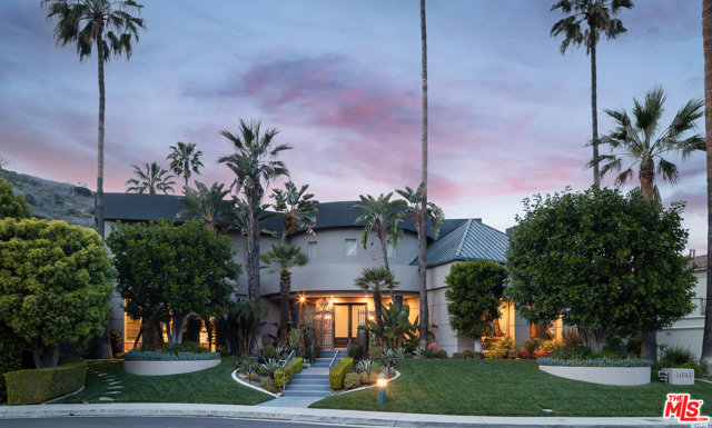 14043 Aubrey Road Beverly Hills, California In the highly-coveted, guard gated Mulholland Estates awaits this remodeled & fully upgraded contemporary oasis previously owned by a celebrity basketball player. At the end of a quiet, tree-lined cul de sac this gorgeous estate provides maximum security, an expansive resort-like yard, and mesmerizing views. Be welcomed by a soaring 2-story entry beautifully accented by marble floors, built-in aquariums and grand archways for seamless flow to the living and dining spaces. Sleek gourmet kitchen can cater to any needs with high-end Viking & SubZero appliances, built-in TV, & pantry. The spacious and sumptuous primary suite boasts a private lounge with kitchenette, oversized walk-in closets, and spa-like bath with dual vanity sink, soaker tub & glass shower. Descend to the lower-level where you will find luxurious amenities including a fitness studio, game room, bar, opulent theater and music studio. Home features include generous guest rooms, formal dining, golf simulator, laundry room, elevator, & much more. Relish association luxuries which include club house, tennis courts, & 24-hour guards. Entertain to your hearts content in the jaw-dropping yard w/basketball court, pool, waterfall, spa, pavilion, BBQ, fire pit & patio space for lounging while enjoying the city light view. A true dream in a world-class location, this gated compound has it all!