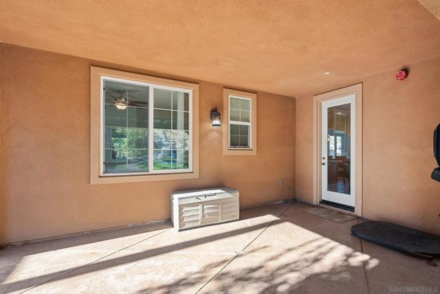 Exit from kitchen to covered patio leading out to back yard oasis.