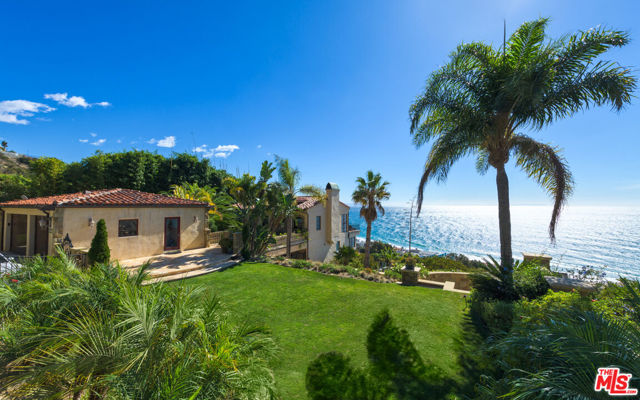 This Tuscan-inspired estate encompasses nearly 5,000 square feet of resort-style living that offers an exquisite lifestyle. The property overlooks the Pacific Ocean to the south and offers completely unobstructed 180-degree coastal views. Entering the living room over the distressed wood flooring, the panoramic view is accentuated by arched windows and double French doors leading out onto the expansive patio, which can be protected from the sun by an electric awning. Inside, you can cozy up to the stone fireplace and take in the breathtaking views. There is a bedroom that has been converted into a showcase office with an adjacent full bathroom. Stepping out past the expansive grass yard on the double lot and onto the patio deck, you'll enjoy your own piece of paradise as you soak in the top-of-the-line Bullfrog Spa and enjoy cooking on a commercial-class natural gas BBQ while you sit around the natural gas stone fire pit, or get grounded in the Zen-style garden that features a variety of 8 different species of Palm trees with a delightfully soothing 20-foot waterfall. The large deck boasts Trex decking for lifetime enjoyment, outdoor lighting that winds around the mature Coral tree, and extra electrical outlets for all your needs. A well-laid-out floor plan inside ensures conversations can be seamlessly continued as guests flow from the living room to the kitchen and adjoining dining area. The kitchen features designer commercial-grade appliances filtered and instant hot water, a Wolf range, and stone accents to complement the flooring, bringing a taste of the Tuscan lifestyle to this Malibu estate. The second-floor master suite boasts dual closets, access to the deck and Zen Garden, capturing the ocean views, and an ensuite bath with stone flooring, a freestanding tub, and a huge steam shower. Situated at the end of the hallway, it offers complete privacy. The additional two bedrooms on this floor are generously sized and have direct ocean views and balcony access. There is an extra-large third closet built out for those who need secure space for their finer items.The large 3rd floor is dedicated to fun. It features a built-in bar and wine closet area, plenty of room for billiards and other table games, and much more. The showstopper of this home is the professional-grade movie theatre, complete with THX surround sound and a 3D projector! From the stone-accented wet bar, you walk through the curtains and enter this lavish theatre room. Rich wood ceiling paneling and wall fabric that allows for perfect sound baffling, lighting along the aisles, and plenty of seating will have you feeling like you have a private commercial theatre in your home. Along with a 3-car garage, the property has an at-home gym complete with a full bath. This one-of-a-kind property is a must-see with more amenities and tech features than we can list! It's impossible to describe the feel of this home that exudes luxury and class while expressing its personality. Schedule your private tour today. EQUITY membership to the LA COSTA BEACH and TENNIS CLUB. Dues are $660 per YEAR for Beach and $200 for tennis.