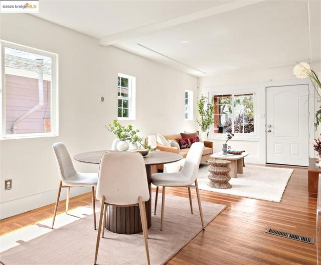 Dining area featuring wood finished floors and beam ceiling