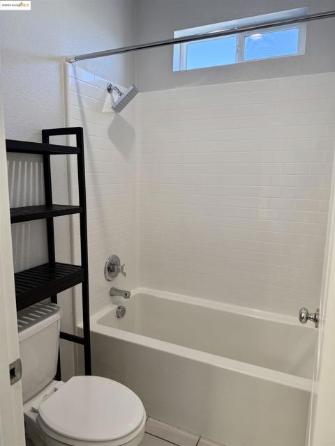 Full bath with shower / tub combination and tile patterned floors