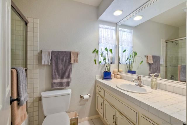 Full bathroom with tub in shower.