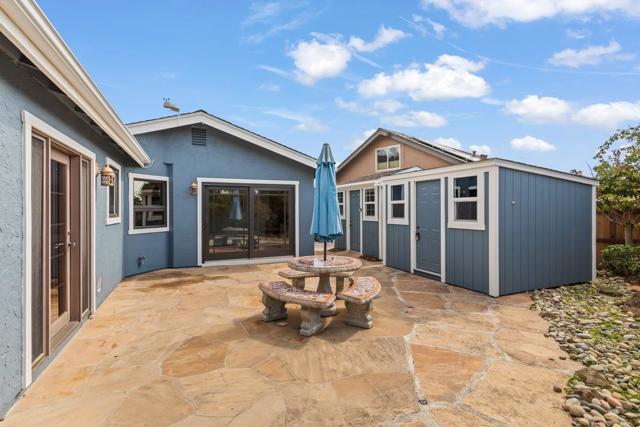 Patio with two storage sheds