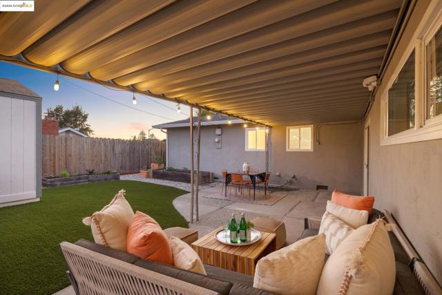 Fenced backyard featuring a patio area, an outdoor hangout area, and outdoor dining area