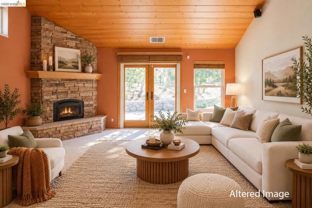 Stacked stone fireplace with a wood mantle