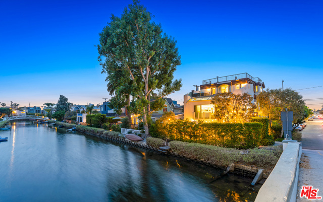 241 Carroll Canal Venice, California Breathe in the ocean air in this incredibly rare find located in the Venice Canal. This 5 bed / 3.5 bath contemporary home with parking for 6 cars sits on a corner lot with views from every floor and plenty of natural light that shines throughout. Enjoy the weather and entertain in style on the front patio with built-in BBQ, firepit and plenty of seating that flows into the large living room with a fantastic wet bar. The bottom floor also contains 2 guest beds and a bathroom. The main floor features an open concept living and dining room highlighted by high ceilings throughout and floor to ceiling French doors that peer out over the canal. Through the hallway you'll find two more large guest bedrooms and a large guest bath. The entire third floor boasts an expansive master suite that flows out onto a large balcony with breathtaking views that you can soak in as you relax in the hot tub. The master suite is rounded out by a stunning spa-like bath and plenty of closet space. Relax underneath the stars on the massive rooftop deck with 360-degree views. Whether you want to entertain or relax in style, this home offers a once in a life opportunity to enjoy all the best that Venice has to offer.