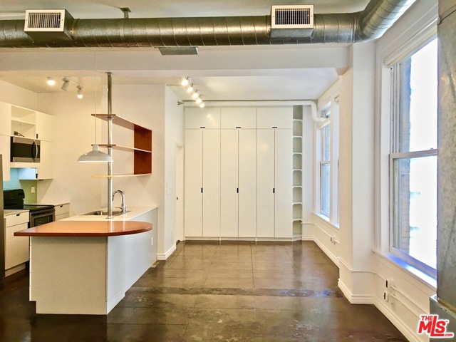215 W 7Th Street 603 Los Angeles, California This 6th floor open loft in the historic Bartlett Building is available immediately. Nicely upgraded features include a remodeled kitchen and bathroom, abundant and bright overhead lighting, built-in floor-to-ceiling closets, and an in-unit washer/dryer. This apartment faces East towards the interior courtyard and has views of Spring St. via the alley. Also enjoy beautifully polished concrete floors throughout and large original windows for lots of light. Full kitchen appliances include a microwave, dishwasher, electric stove/oven, garbage disposal, and refrigerator. Be in the heart of the Downtown LA Historic Core where you're in close proximity to shopping, dining, nightlife, and public transportation. The building has a lovely roof top lounge area fully furnished and perfect for outdoor dining with 360-degree views of the Downtown skyline, and a 24/7 concierge for security and convenience. Parking included for one car in the private garage. Space #15, lower level.