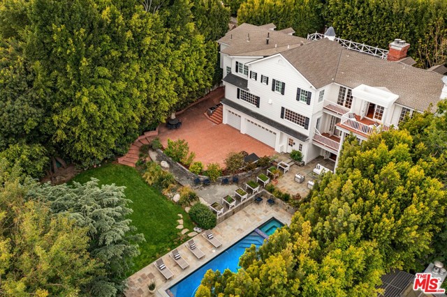 10464 W Sunset Boulevard Los Angeles, California Stately reimagined Traditional beauty featuring 3 Levels of luxurious living with Paul Williams influences. A classic center hall floor plan with gorgeous entry and sweeping staircase. Grand sized living room offers a great room concept with an abundance of natural light, hardwood floors, crown moldings and wood burning fireplace. Adjoining the living room is the elegant library that features a fireplace, custom built-in cabinets and overlooks the lush grounds and a private veranda. Incredible state of the art kitchen with all the amazing bells and whistles one can imagine. Charming dining room, powder room and guest room complete the main level. Upstairs features a master retreat with fireplace, sitting area, wet bar and private balcony with views to Century City, dual baths and custom built closets. There are an additional 4 bedrooms. The entire lower level is an amazing entertainer's paradise that includes a large family room with a lodge like fireplace, full kitchen, wine room and access to the massive grounds. Magnificent backyard with saline pool and spa, large grassy lawn and pool house (currently being used as a gym). Former home of hotel royalty, and situated on a rare manicured approx half acre. Large gated motor court for utmost privacy and security for this premier estate.