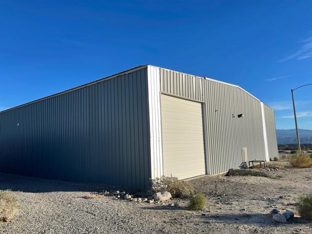 Huge warehouse and on property living. Excellent opportunity in the North Palm Springs area bordering Desert Hot Springs. The property consists of a 960 sq. ft. modular home or office space with 3 bedrooms and 2.5 bathrooms and a 10,000 sq. ft. metal warehouse shop inclusive of: one end-to-end Semi truck sized Bay with roll up doors on each side, two large Bays, a man door on the warehouse shop including two additional office spaces, large bathroom area with shower, and bonus elevated storage space. The property features a fenced area surrounding the structures. The site also features surplus land to the West of the fence to Indian Canyon. Septic and private water well. The subject property is situated on 9.7 acres and is zoned W-2 Controlled Development Area (Residential). This is a multi-opportunity property. Maybe for a car collector. Also for lease.