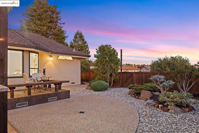 Fenced backyard featuring a deck
