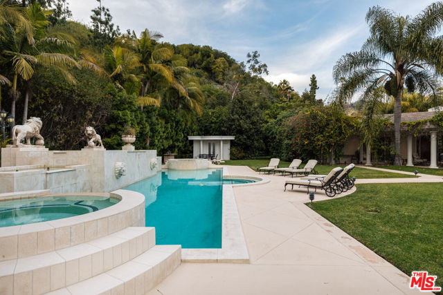 917 Loma Vista Drive Beverly Hills, California Revered as one of the most notable trophy lots in Trousdale and sited just above the landmark Greystone Mansion, this incomparable 2 acre compound boasts expansive views from Downtown to Century City and sits privately behind gates. Completed in 2002, this grandfathered in estate bears 16.5-18 foot roof pitches, an unparalleled rarity in Trousdale. The meticulously refined main residence offers 5 bedroom suites and 9 baths, with a detached guest house offering 3 beds and 2 baths with a kitchen, dining and living rooms. The outdoor oasis features a Venetian style stone pool and spa with outstanding water features, a standalone pool house and resort like landscaping, offering the ultimate in privacy, seclusion, and elegance. This marquee estate is uniquely positioned as both a world-class redevelopment opportunity that also offers a true, one-off chance to acquire a magnificent piece of residential craftsmanship residing in one of the most exclusive enclaves in the world.