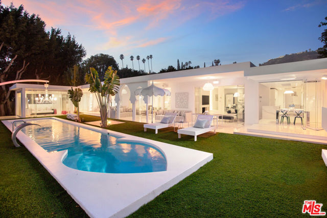 Welcome to this serene and immaculate Trousdale Estates modern oasis. Completely remodeled with the highest attention to detail in 2017, this gated 5 bedroom, 5.5 bathroom home offers beautiful views, ample space for entertaining, and the finest fixtures. With quartz floors with mosaic glass detailing, Venetian plaster walls, skylights, and custom cut Italian doors, this is one of the finest homes available in Trousdale Estates. A beautiful foyer welcomes you into a bright open floor plan living area with a 2-sided fireplace, separate dining and breakfast areas, and floor to ceiling glass doors framing the gorgeous city to ocean view. Off of the kitchen are 3 bedrooms, each with their own bathroom, and one with a private garden area. On the other side of the living area is the master wing with a spacious master bedroom, spa, sauna, steam room, and additional bedroom. Completing the property is a bonus room next to the pool perfect for home workouts or more entertaining.