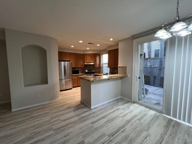 KITCHEN, BREAKFAST COUNTER, AND DINING AREA.