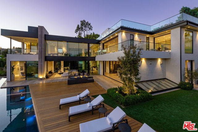 1332 LAUREL Way Beverly Hills, California Exceptionally engineered, state-of -the-art architectural home situated in Beverly Hills featuring a seamless indoor /outdoor lifestyle with jetliner views from Century City to the Pacific Ocean. Combining an elegantly warm organic curation with cutting-edge technologies is the latest Masterpiece from Jae Omar Designs. With a culmination of the rarest, most unique materials and finishes sourced from around the globe this modern technologically advanced smart home boasts impressive scale rooms with high ceilings throughout, a 10 car gallery garage, soundproof Dolby Theater, world class gym with spa, Luxurious Master suite with showroom quality closet & spa inspired bathroom, impressive water and fire features, a rooftop terrace, temperature controlled wine room, cigar lounge and much more. Within minutes to the Beverly Hills Hotel and Rodeo Drive, this property affords its buyer the finest living experience possible surrounded by the finest dining and leisure Beverly Hills has to offer.