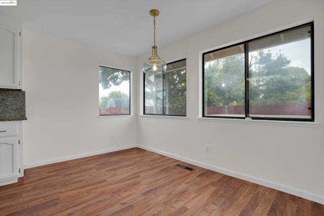 Unfurnished dining area with light wood finished floors and baseboards