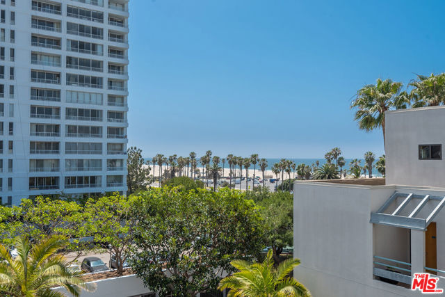 SoCal beach living at it's best!  Rare opportunity in Sea Colony III, one of Santa Monica's most prestigious communities, right across from the beach near Main St. shops and restaurants.  Relax and enjoy the ocean views, palm trees and beautiful sunsets.  Bright, spacious 2 bd. 2ba unit flows nicely with open concept kitchen complete with eat in area or additional office space, stainless refrigerator and wine fridge, leading to generous dining area and living room with fireplace, floor to ceiling windows looking out to the wrap around balcony with views.  Master suite with walk in closet, built in storage and large soaking tub.  Lots of cabinet space, recessed lighting, in-unit laundry, central A/C. Resort-like amenities include 24-hr security, pool, fitness room and clubhouse.  Extra storage cage on the 2nd floor.  Side by side parking. You won't want to miss this upper floor, 2 bd/ 2 bath beach beauty.