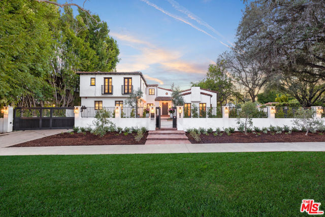 Set behind gates in the highly coveted Beverly Hills flats, this ultra-private and custom Spanish Estate showcases ~6,600 square feet of unparalleled luxury and exquisite design. Beyond the private motor court, the dramatic entrance welcomes you with soaring vaulted ceilings, a sweeping staircase, and impressive wood beams. The 2-story home offers 6 bedrooms, 10 bathrooms, several immaculate living spaces and a separate detached guest casita. The impressive chef's kitchen is outfitted with top-of-the-line appliances and features a grand 14-foot center island that is open to the formal dining area. The main level is encased by both French floor-to-ceiling doors and glass pocketed doors allowing for seamless indoor/outdoor living. Surrounding the property in its entirety, the stunning manicured grounds host a fenced-in salt system pool, spa, built-in BBQ, and vegetable gardens. On the second level, live lavishly in the primary bedroom suite with a beautiful fireplace, his/her marble bath