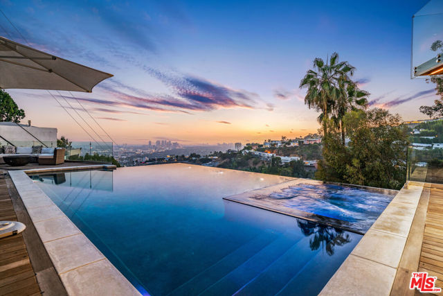 This 3,500 sqft  Hollywood dream home has a beautifully designed large infinity pool with an unobstructed view of the city.  This completely automated smart home Has a chefs kitchen with Miele appliances feature that caters to your every desire. With a bonus open-air fitness room to help keep you fit while enjoying the outdoors.