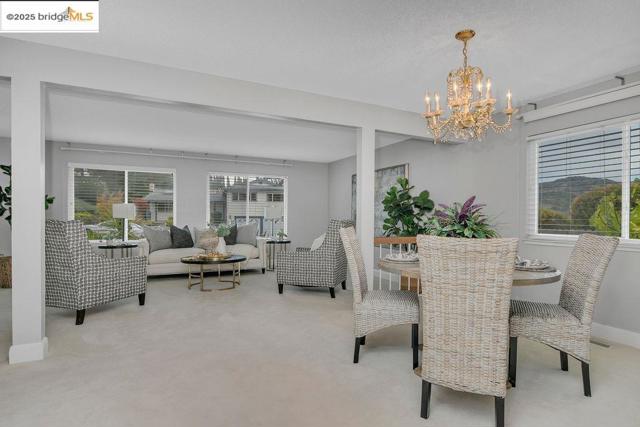 Dining area featuring light carpet and a chandelier