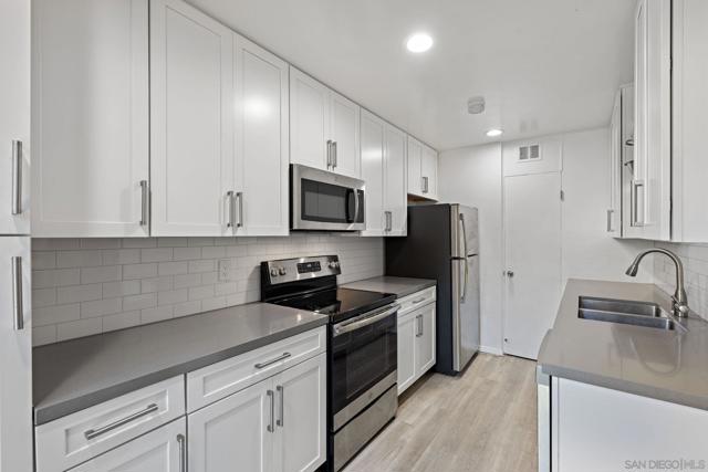 Remodeled kitchen with Stainless steel appliances and plank flooring